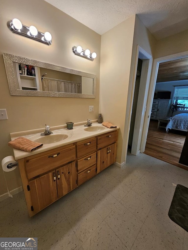 bathroom with a textured ceiling and vanity