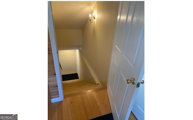 stairs featuring hardwood / wood-style flooring