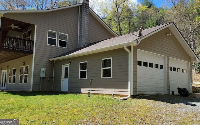 exterior space with a garage, a yard, and a balcony