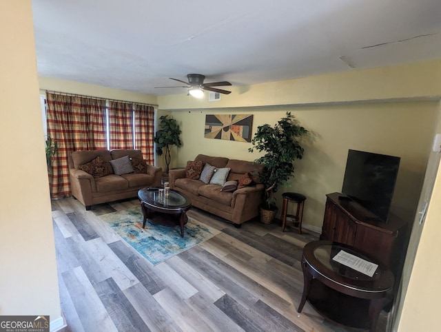 living room with wood finished floors and a ceiling fan