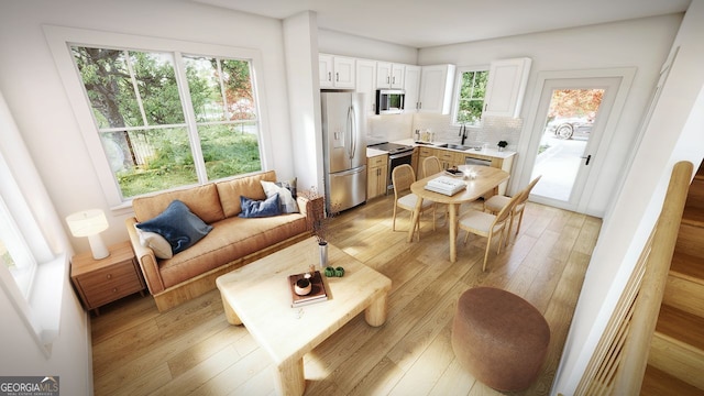 living room with sink and light hardwood / wood-style flooring