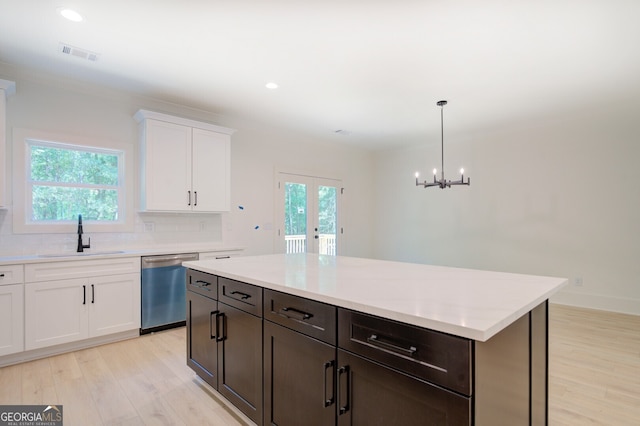 kitchen featuring light hardwood / wood-style flooring, tasteful backsplash, sink, and pendant lighting