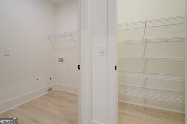 washroom featuring hookup for a washing machine and light wood-type flooring