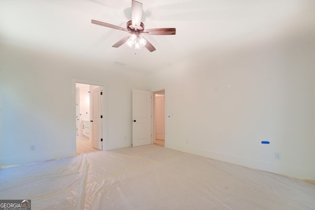 unfurnished room featuring ceiling fan and light carpet