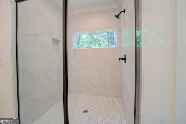 bathroom featuring a shower with door