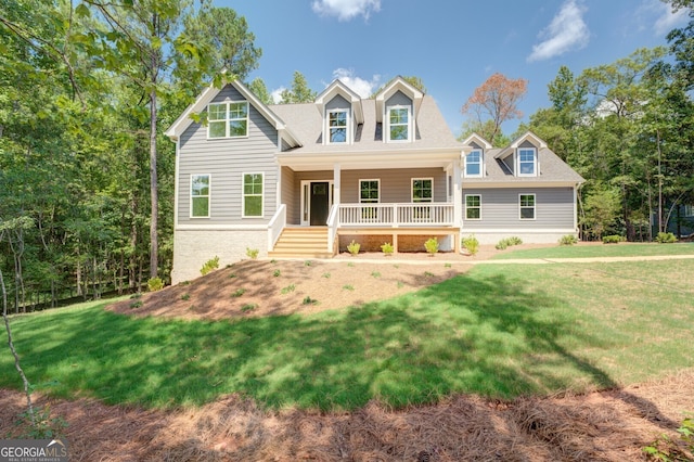 view of front of house with covered porch and a front lawn