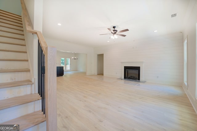 unfurnished living room featuring light hardwood / wood-style flooring and ceiling fan