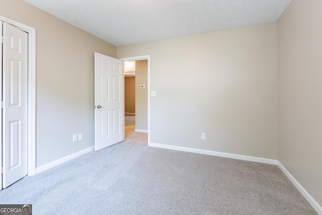 unfurnished bedroom featuring light colored carpet