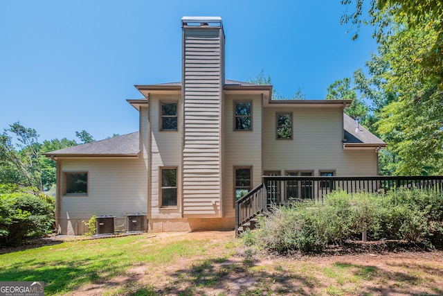 rear view of house featuring central AC and a deck