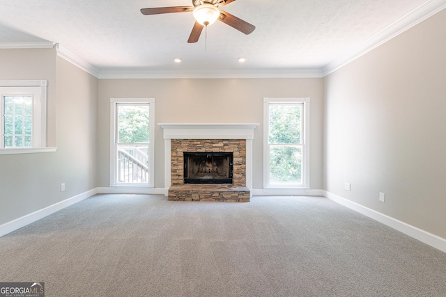 unfurnished living room featuring ornamental molding, light colored carpet, a textured ceiling, and a fireplace