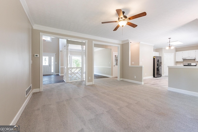 unfurnished living room featuring light carpet, ornamental molding, and ceiling fan