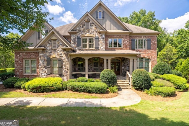 craftsman inspired home with a front yard and a porch