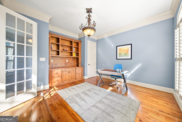 office area with light wood-type flooring and crown molding