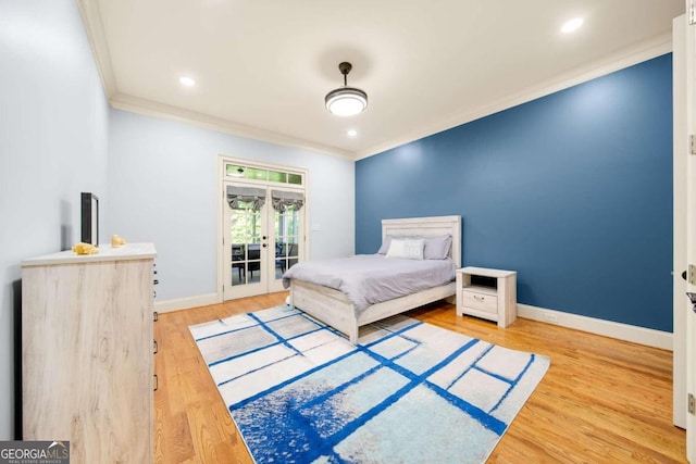 bedroom featuring french doors, access to exterior, hardwood / wood-style floors, ceiling fan, and crown molding