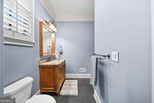 bathroom featuring vanity, tile patterned flooring, toilet, and ornamental molding