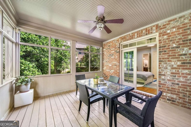 sunroom / solarium featuring ceiling fan