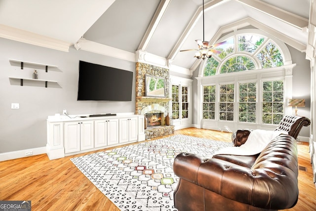 living room featuring a fireplace, lofted ceiling, ceiling fan, and light hardwood / wood-style flooring