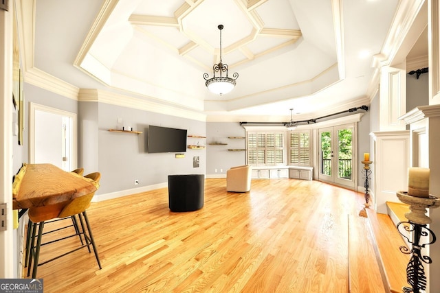 living room featuring hardwood / wood-style floors, a raised ceiling, french doors, and crown molding