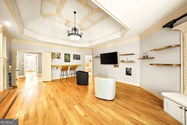 unfurnished living room with ornamental molding, light wood-type flooring, a tray ceiling, and coffered ceiling