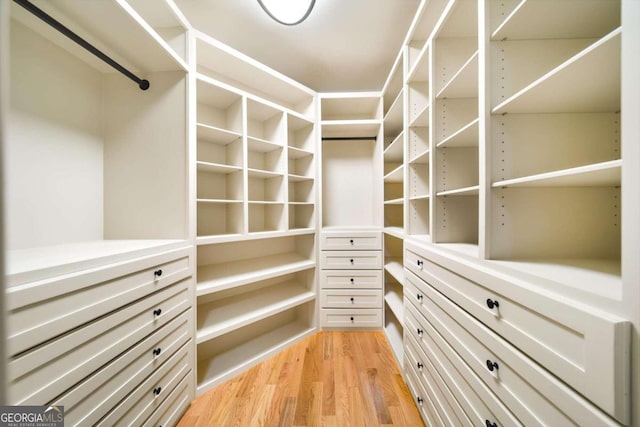 spacious closet with light hardwood / wood-style floors