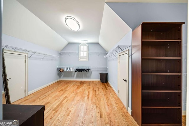 bonus room with vaulted ceiling and wood-type flooring