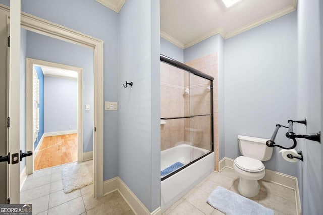 bathroom featuring bath / shower combo with glass door, tile patterned floors, toilet, and ornamental molding