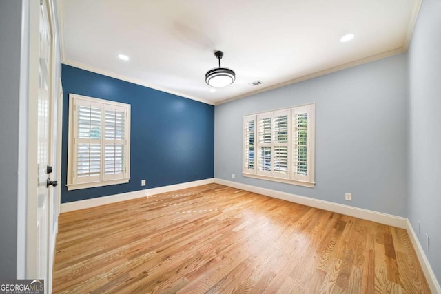 unfurnished room with light wood-type flooring and crown molding