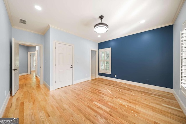 unfurnished bedroom featuring light hardwood / wood-style floors, a closet, and ornamental molding