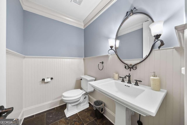 bathroom with toilet and crown molding