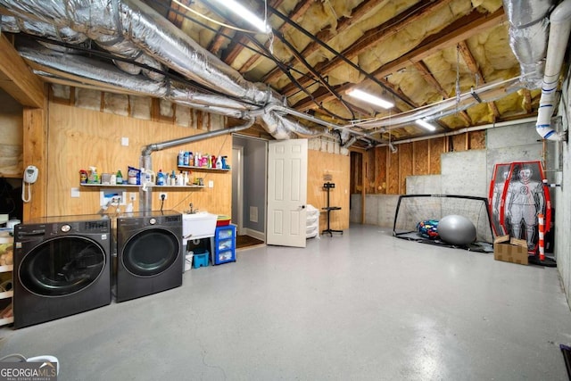 basement featuring sink and independent washer and dryer