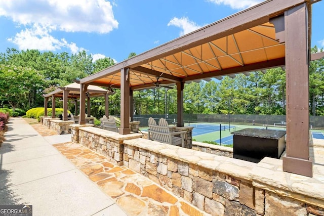 view of patio with tennis court, ceiling fan, and a gazebo