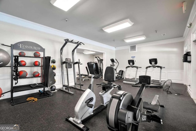 exercise room featuring ornamental molding