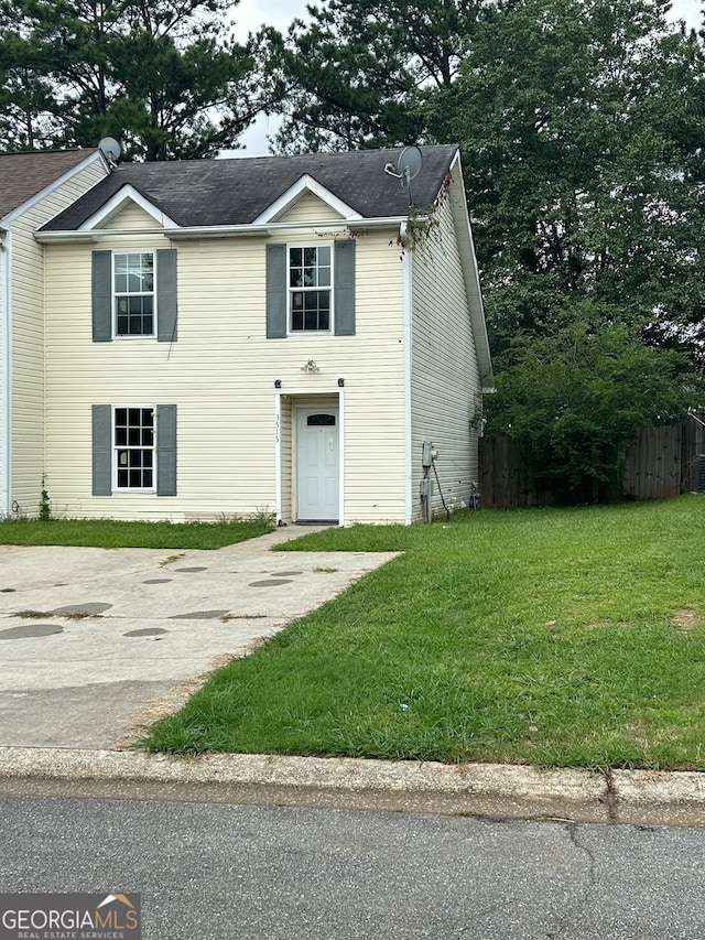 view of front of home featuring a garage and a front lawn