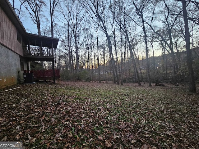 yard at dusk featuring central air condition unit