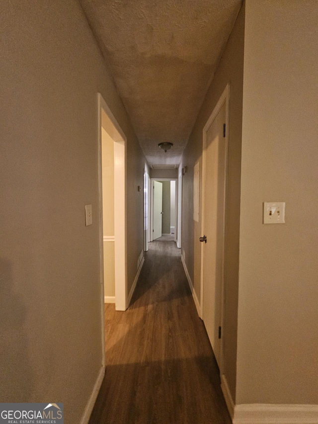 corridor featuring dark wood-type flooring