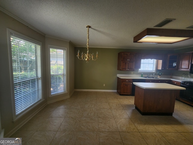 kitchen with a notable chandelier, light tile patterned flooring, ornamental molding, and range