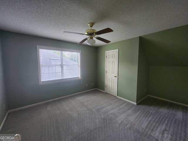 interior space with ceiling fan, a textured ceiling, and carpet