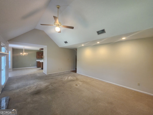 spare room featuring lofted ceiling, light carpet, and ceiling fan with notable chandelier