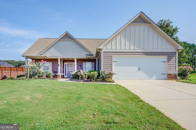 view of front of home with a front lawn, a porch, and a garage