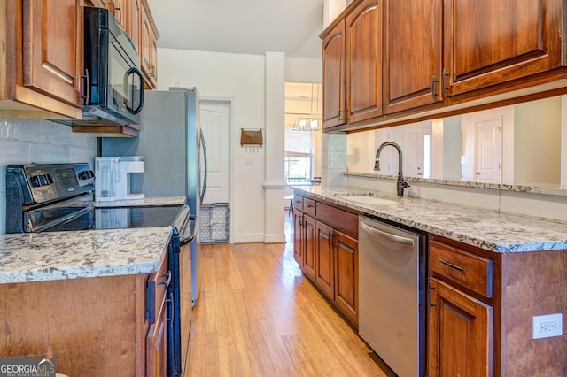 kitchen with electric stove, dishwasher, light wood-type flooring, sink, and tasteful backsplash