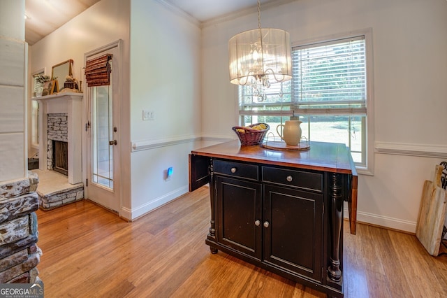 dining area with light hardwood / wood-style flooring, a chandelier, and crown molding