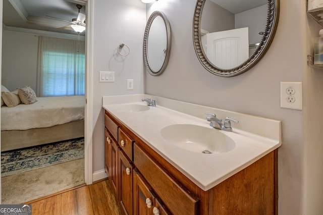 bathroom featuring ceiling fan, double vanity, and hardwood / wood-style floors