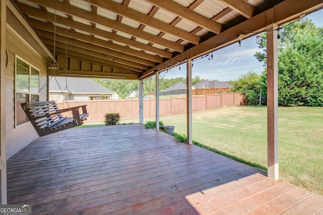 wooden terrace with a lawn