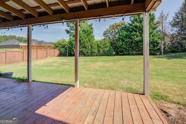 wooden deck featuring a lawn