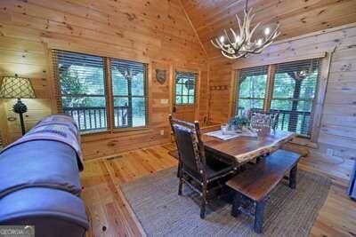 dining room with wood-type flooring, wood walls, lofted ceiling, and wood ceiling