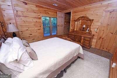 bedroom featuring wood walls and wooden ceiling