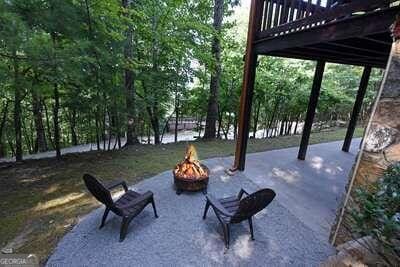 view of community with a deck, a patio area, and a fire pit