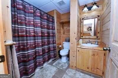 bathroom with a paneled ceiling, tile patterned floors, vanity, and toilet