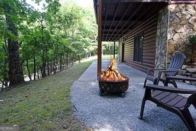 view of yard featuring an outdoor fire pit and a patio area