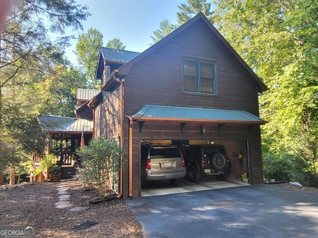 view of side of home with a carport and a garage